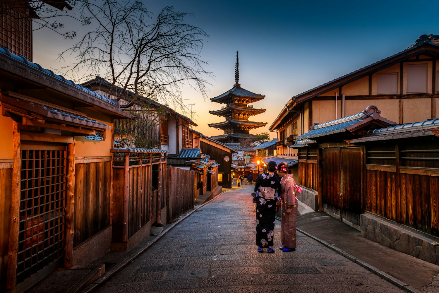 A Kyoto street and pagoda in Japan at dusk